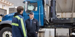 Two men talking next to a Stellar work truck.