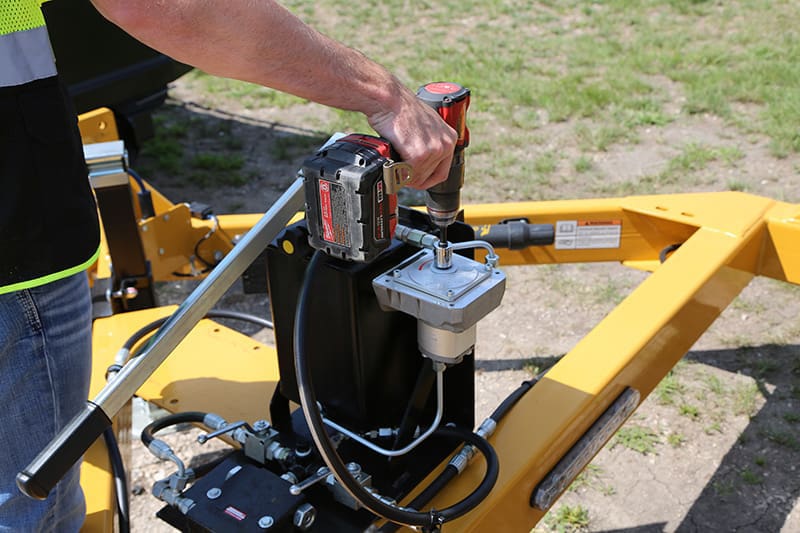 Cordless drill pump in use on telecom trailer.