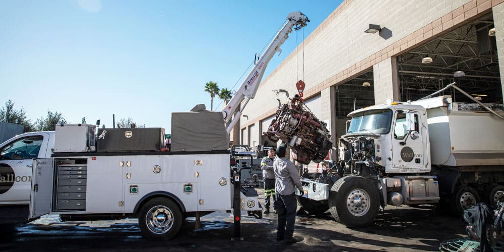The Wall Company mechanics using a Stellar TMAX mechanic truck and crane to remove an engine from a customer's truck.