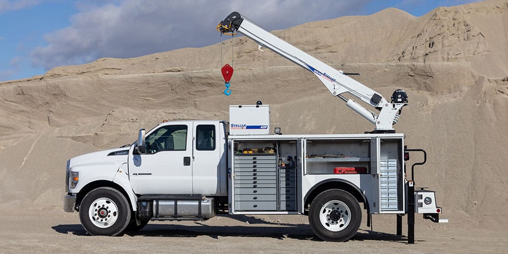 Stellar TMAX mechanic truck on a quarry job site with open doors showing the toolbox system setup.