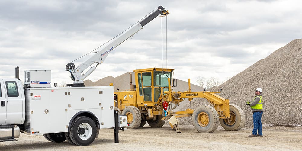 Technician operating a crane on a TMAX2.