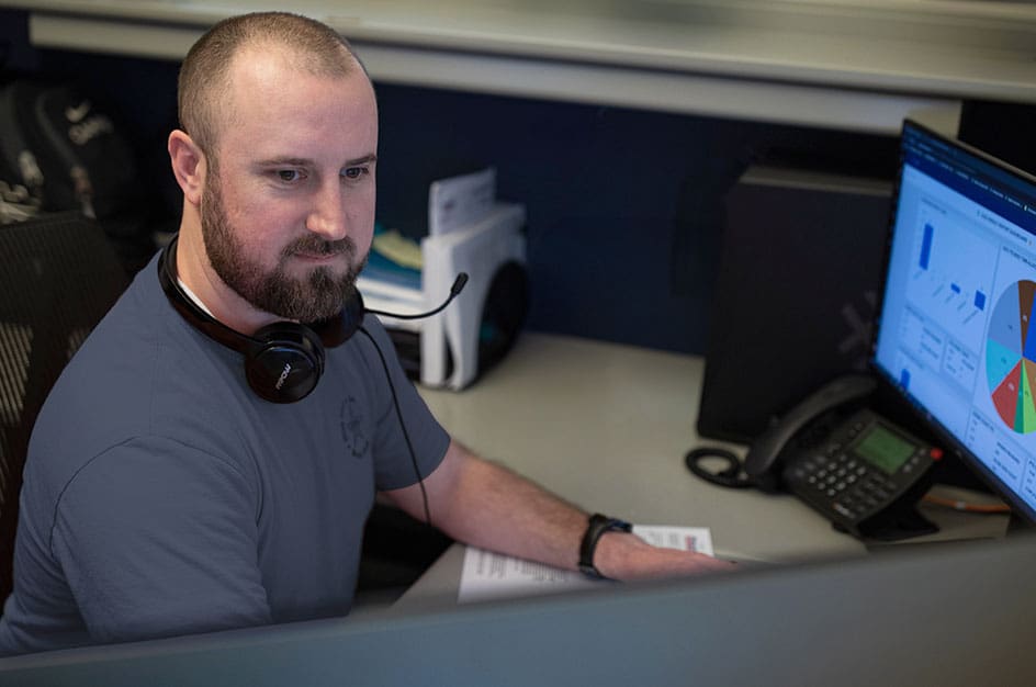 Man in gray shirt working on desktop